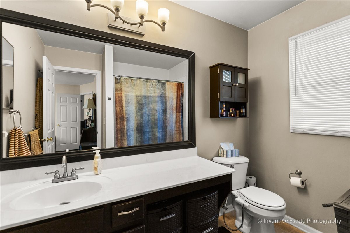 1818 Lobelia Lane Plainfield, IL 60586 - Photo 12 of 19 a bathroom with a sink a toilet and mirror