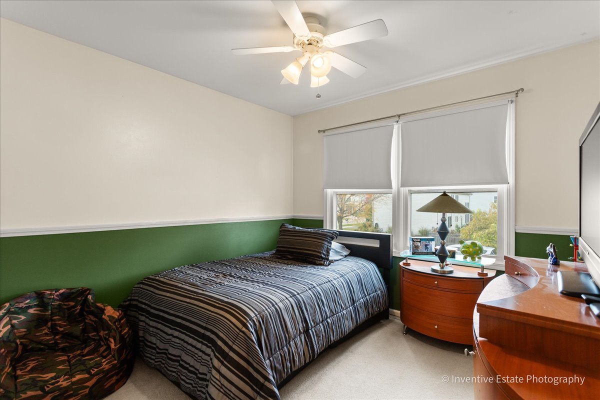 1818 Lobelia Lane Plainfield, IL 60586 - Photo 13 of 19 a bedroom with a bed and a chandelier