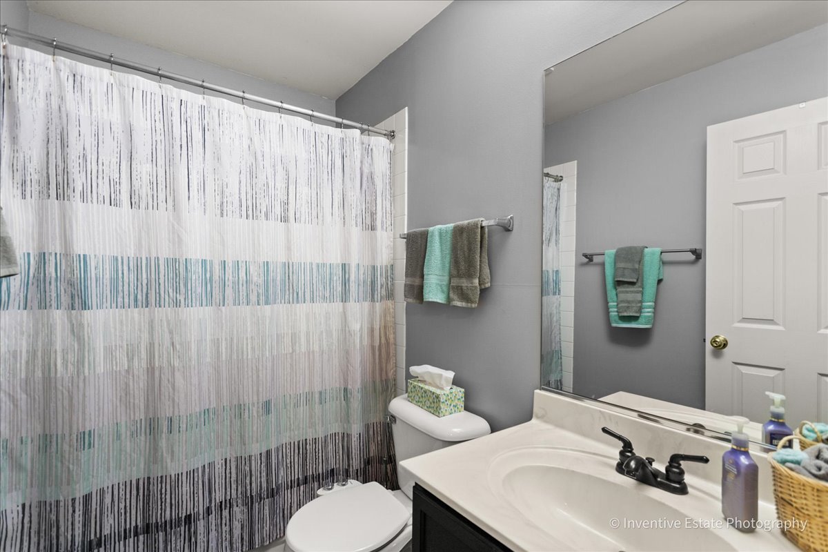 1818 Lobelia Lane Plainfield, IL 60586 - Photo 15 of 19 a bathroom with a sink and a mirror