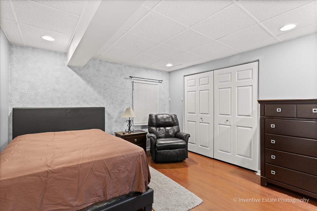 1818 Lobelia Lane Plainfield, IL 60586 - Photo 16 of 19 a bedroom with a bed and wooden floor