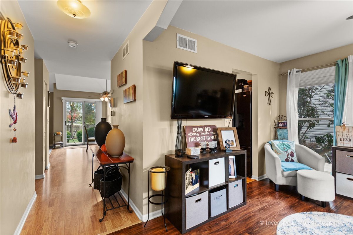 1818 Lobelia Lane Plainfield, IL 60586 - Photo 3 of 19 a living room with furniture and a flat screen tv