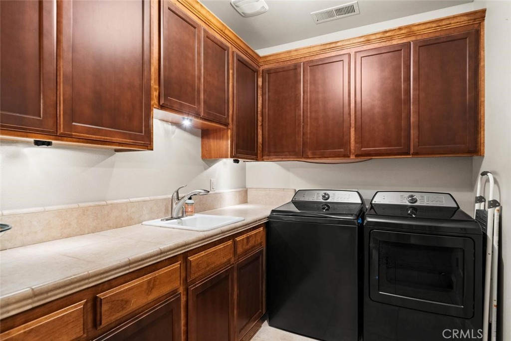 3290 Summit Ridge Terrace Chico, CA 95928 - Photo 36 of 60 Laundry room with utility sink and so many cabinets!