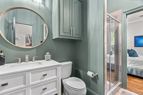 a bathroom with a toilet a sink and mirror