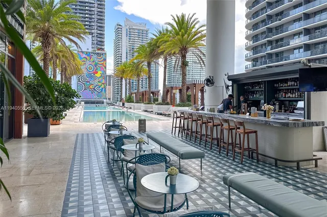 a balcony with furniture and a potted plant