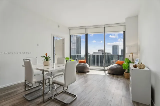 a living room with furniture and large windows