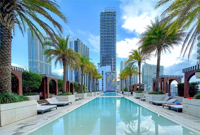 a swimming pool with outdoor seating and yard