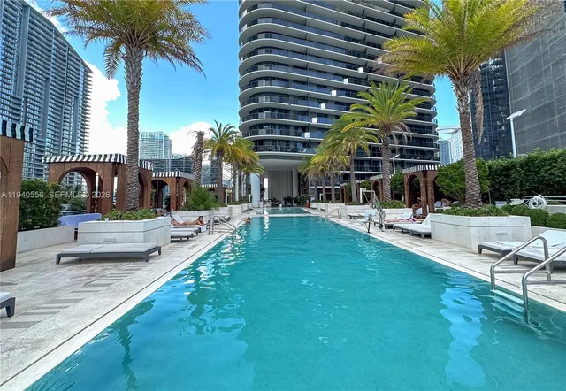 a swimming pool with outdoor seating and yard