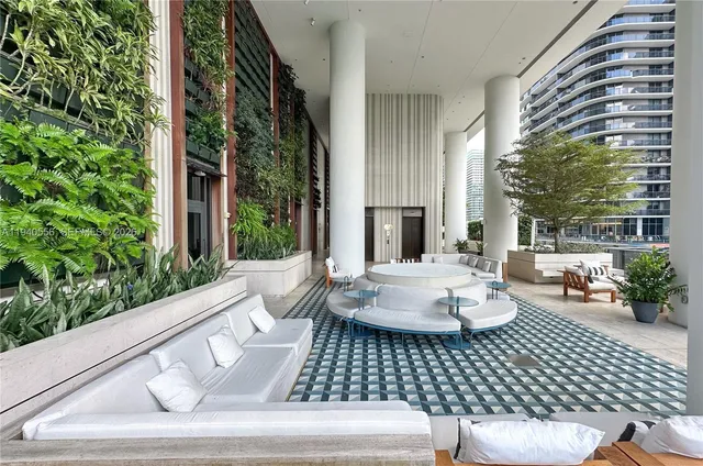 a view of a patio with couches chairs and potted plants