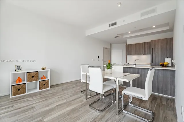 a view of a dining room with furniture and wooden floor
