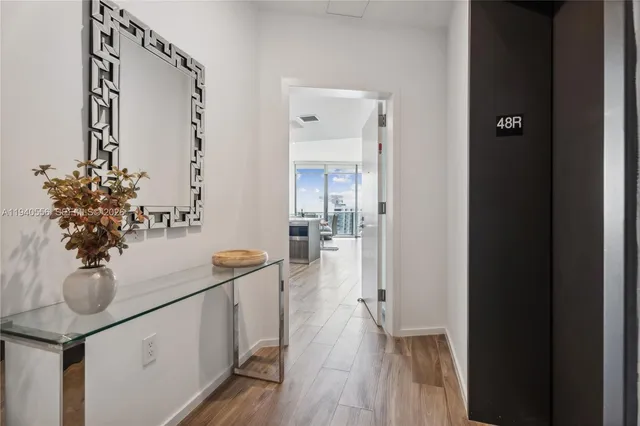 a hallway with dining room and wooden floor