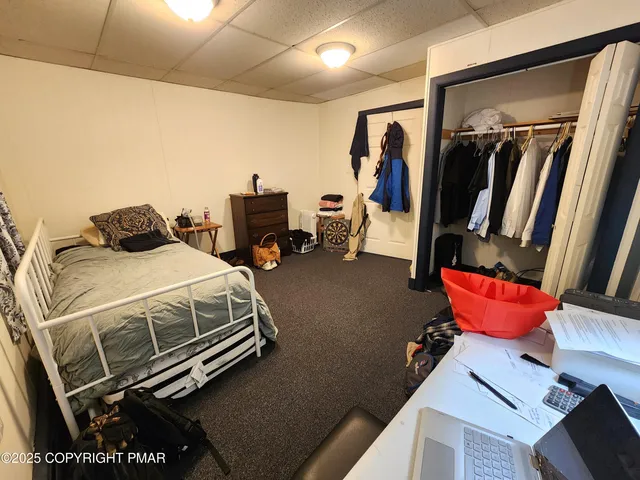 a bedroom with bed and a mirror