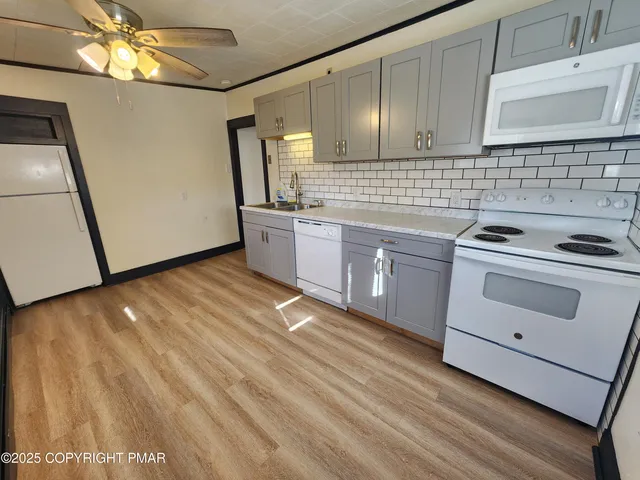 a kitchen with cabinets a sink and appliances