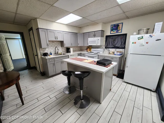 a kitchen with a sink appliances and cabinets