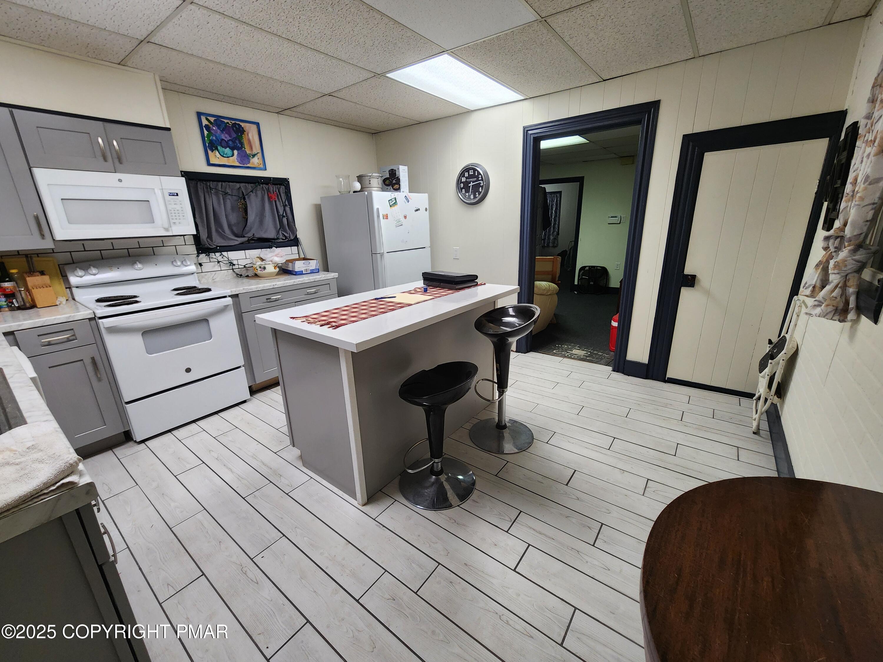 514 North Street Jim Thorpe, PA 18229 - Photo 7 of 34 a view of a kitchen with fridge and wooden floor