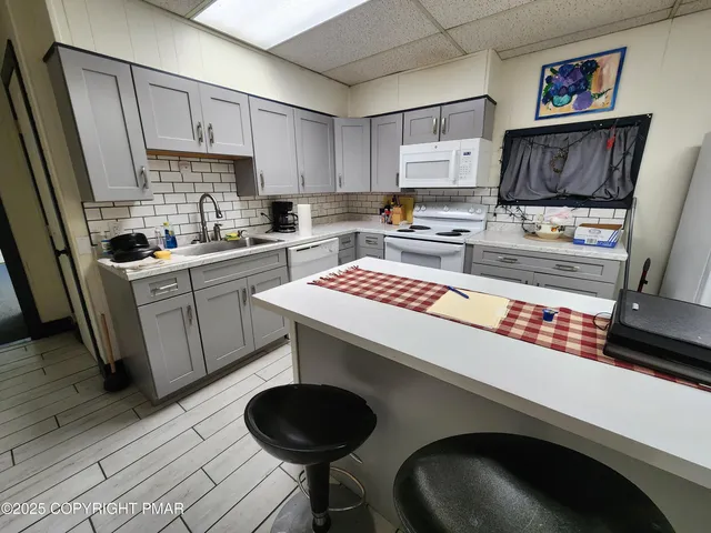 a kitchen with a stove a refrigerator and a sink