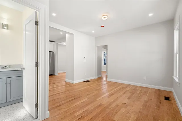 a view of an empty room and wooden floor