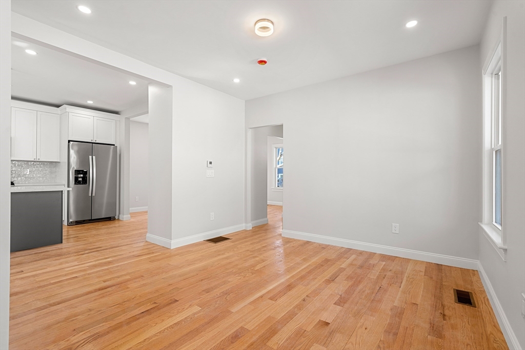 13 River Street, Unit 1 Danvers, MA 01923 - Photo 12 of 23 a view of an empty room with wooden floor and a window