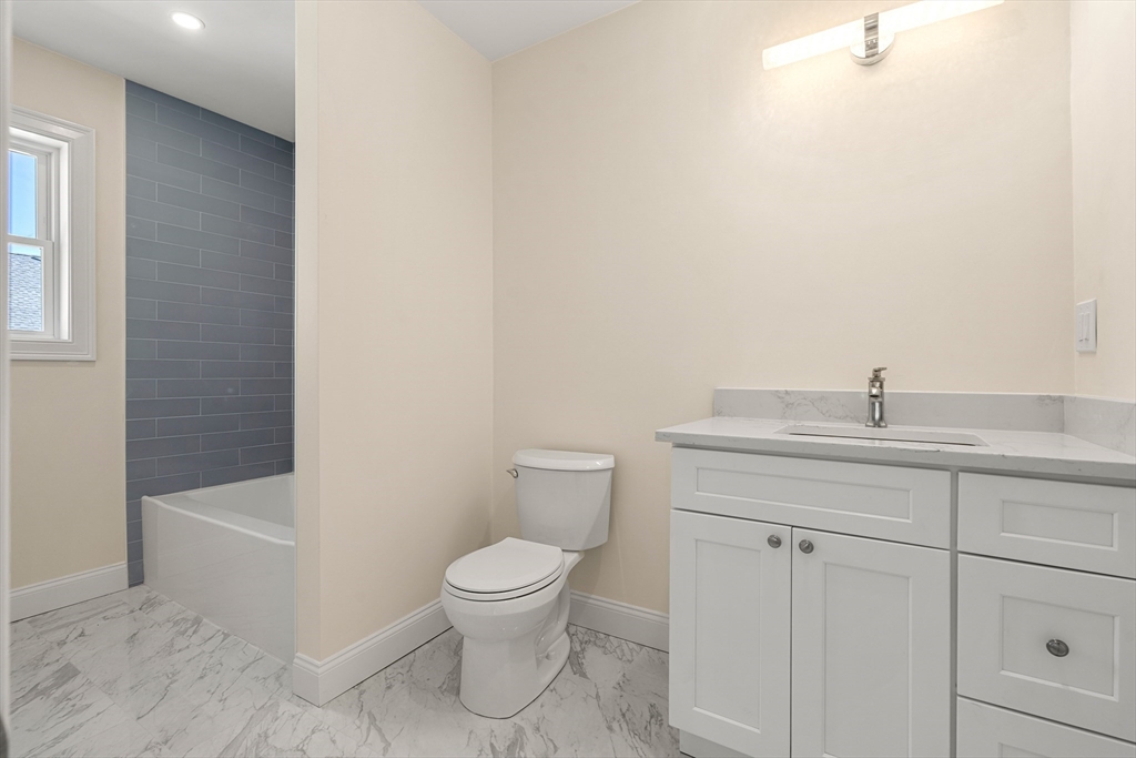 13 River Street, Unit 1 Danvers, MA 01923 - Photo 14 of 23 a bathroom with a toilet a sink and bathtub