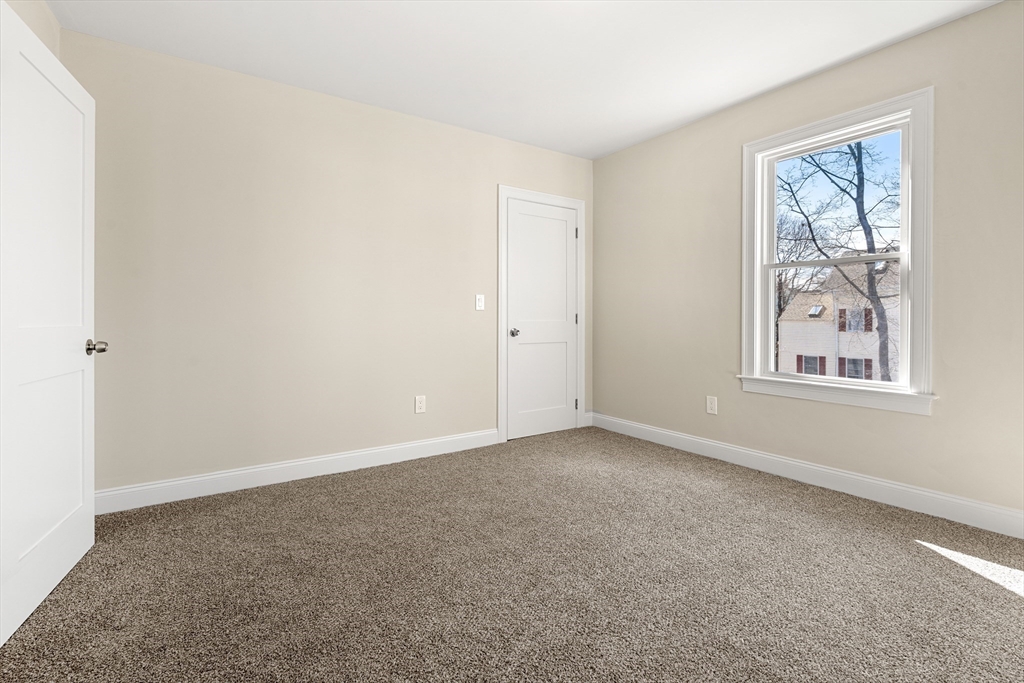 13 River Street, Unit 1 Danvers, MA 01923 - Photo 17 of 23 an empty room with windows and closet
