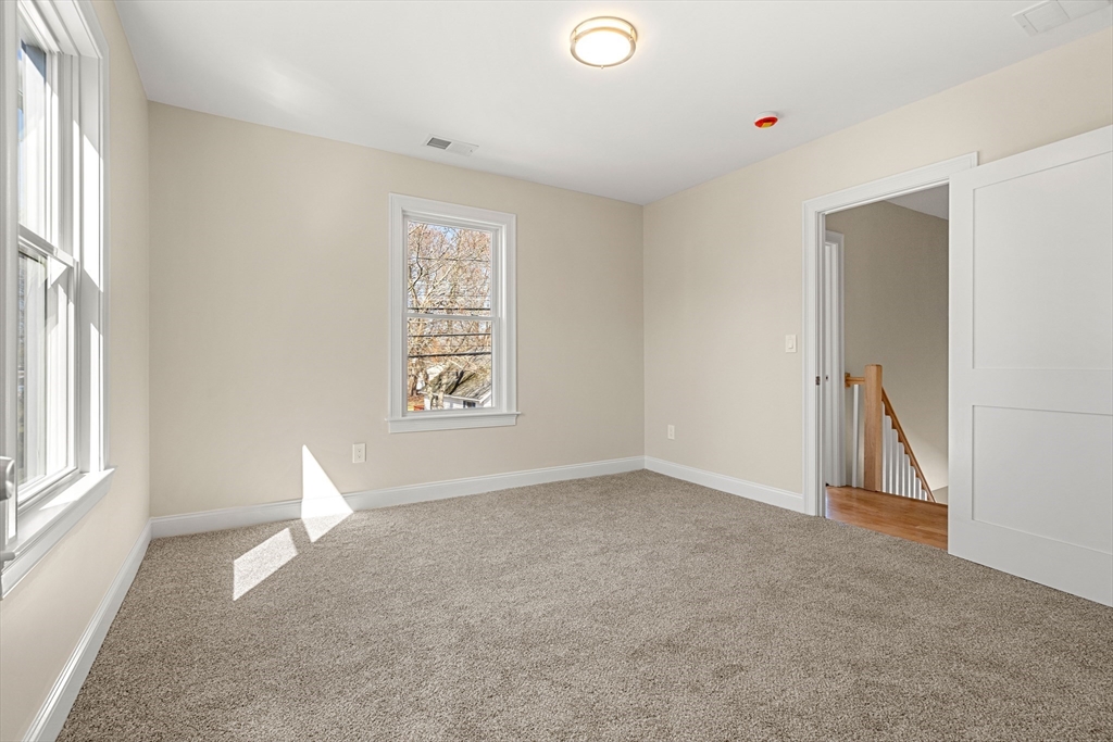 13 River Street, Unit 1 Danvers, MA 01923 - Photo 18 of 23 an empty room with windows