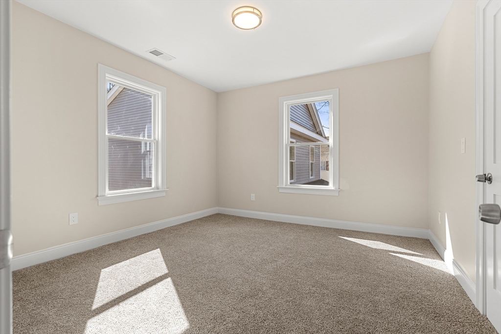 13 River Street, Unit 1 Danvers, MA 01923 - Photo 20 of 23 a view of an empty room with a window
