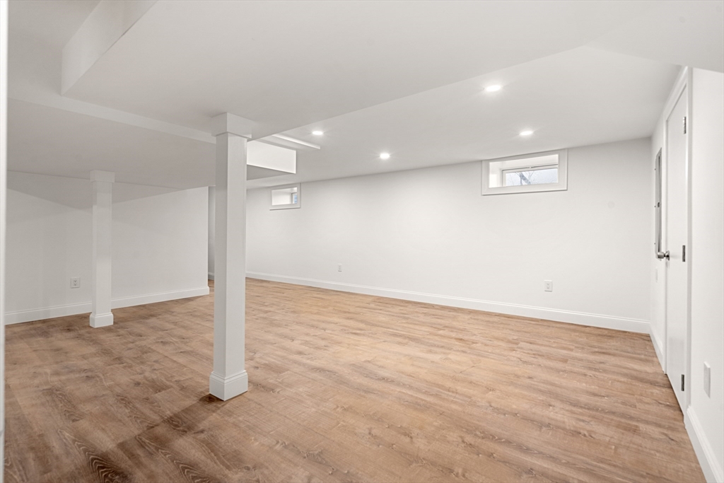 13 River Street, Unit 1 Danvers, MA 01923 - Photo 21 of 23 an empty room with wooden floor and sliding door