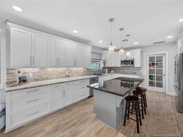 a kitchen with a sink window and cabinets