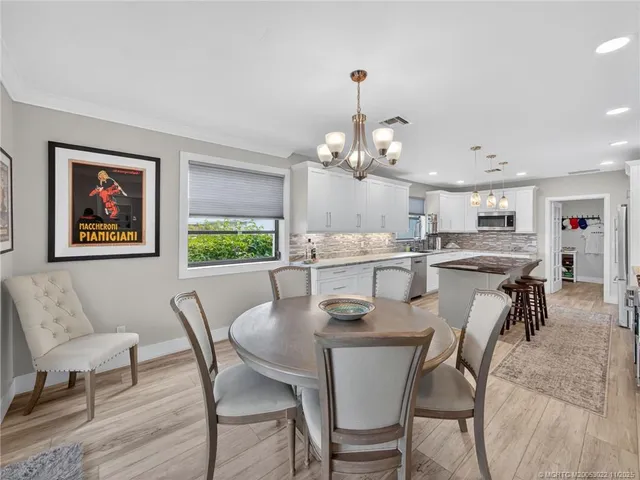 a view of a dining room with furniture and a chandelier