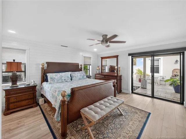 a bed room with a bed a glass door shower and a couch