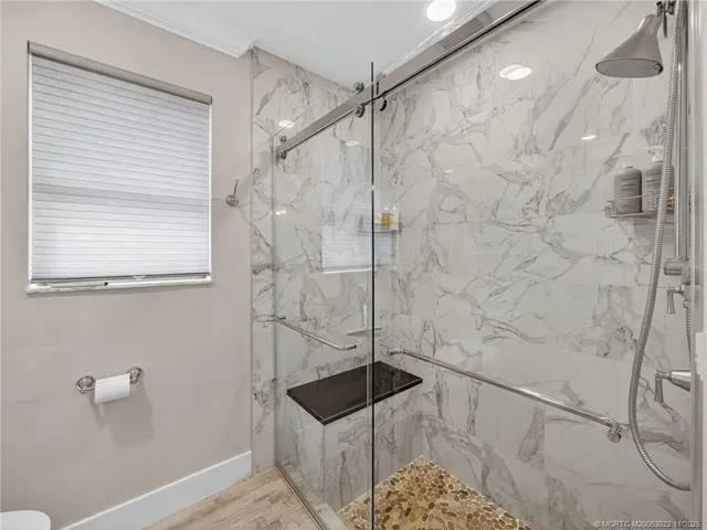 a bathroom with a shower and a sink