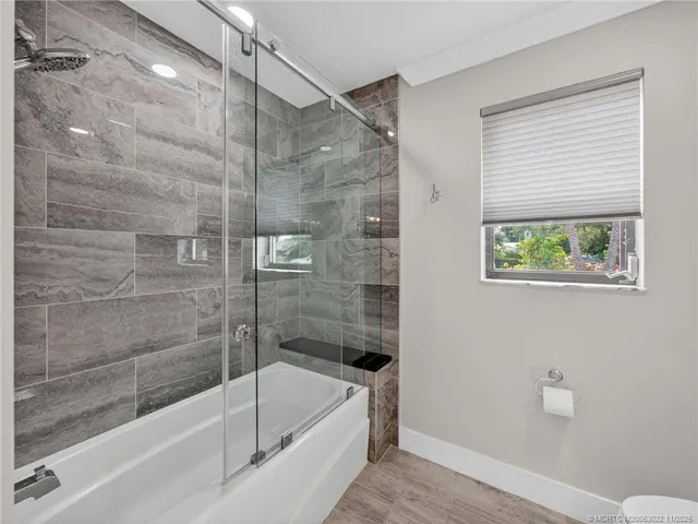 a bathroom with a bathtub and a shower
