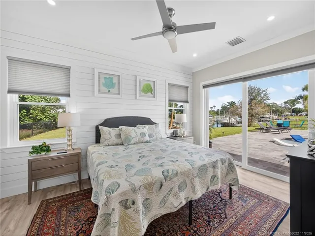 a bedroom with a bed and glass walk in closet