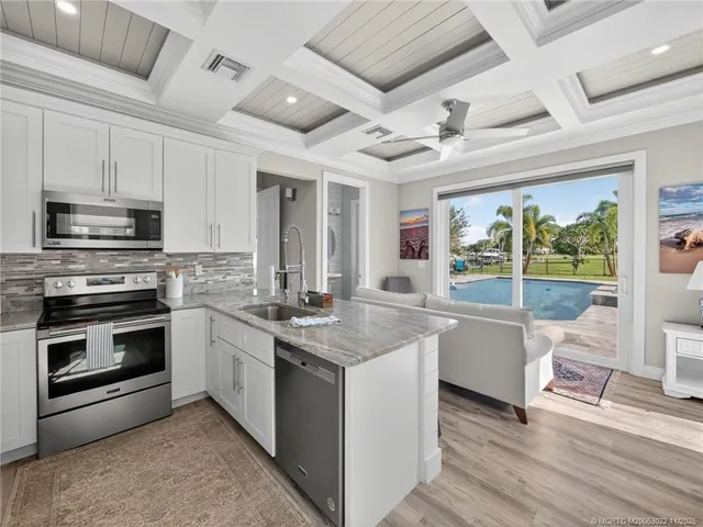 a kitchen with stainless steel appliances granite countertop a stove and a sink