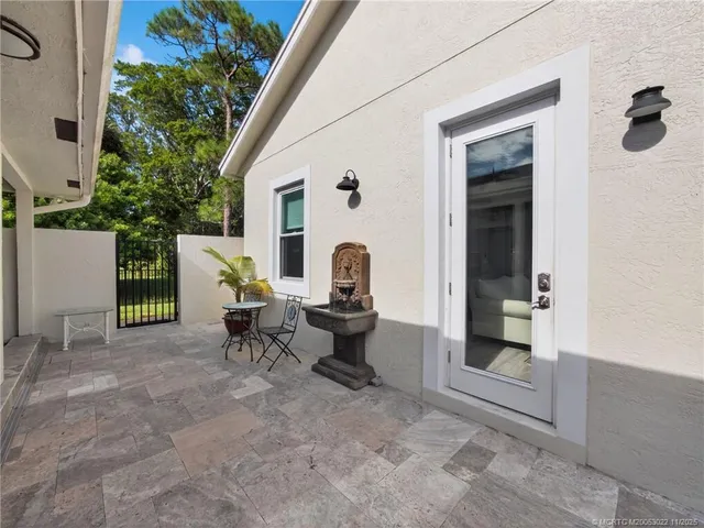 a view of a house with backyard porch and sitting area