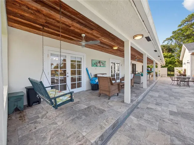 a view of a house with a swimming pool and a yard