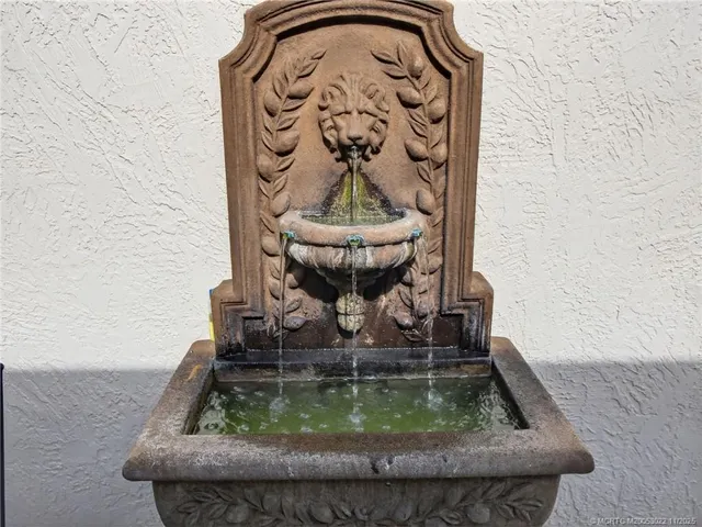 a view of a house with a swimming pool and sitting area