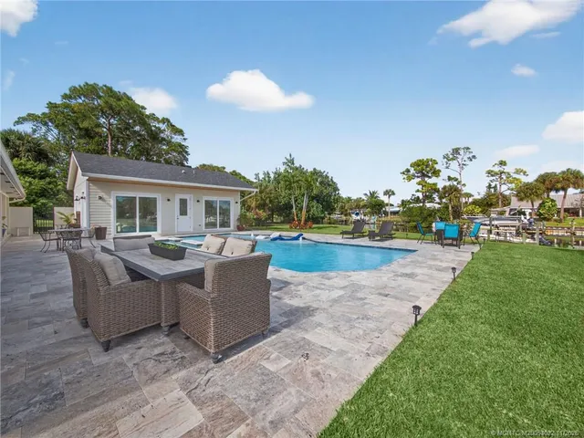 a view of swimming pool with outdoor seating and plants