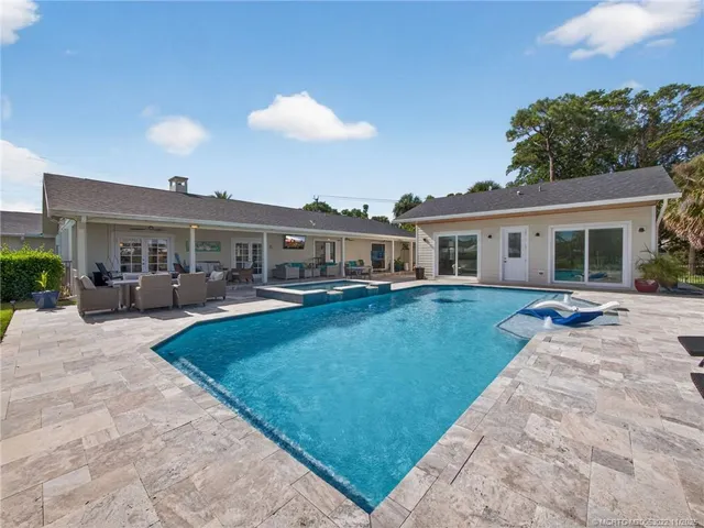 a view of a house with swimming pool and yard