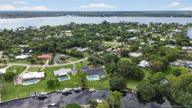 an aerial view of residential houses with outdoor space and swimming pool