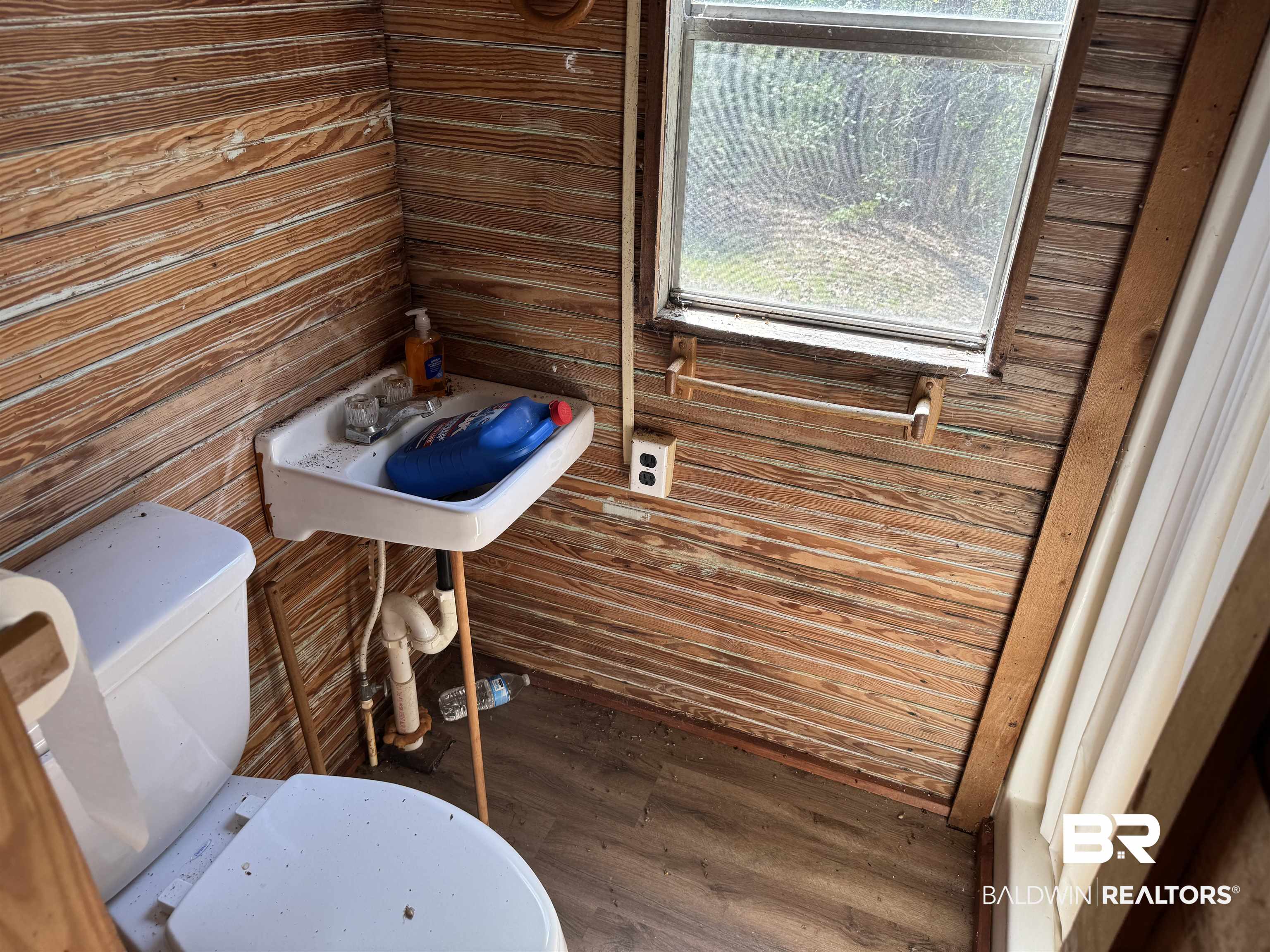 516 Mill Creek Road Frisco City, AL 36445 - Photo 10 of 32 Bathroom featuring dark wood finished floors and wooden walls