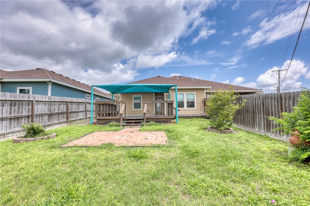 302 Cooper Road, Unit E2 Odem, TX 78370 - Photo 22 of 24 a patio with a table and chairs and potted plants