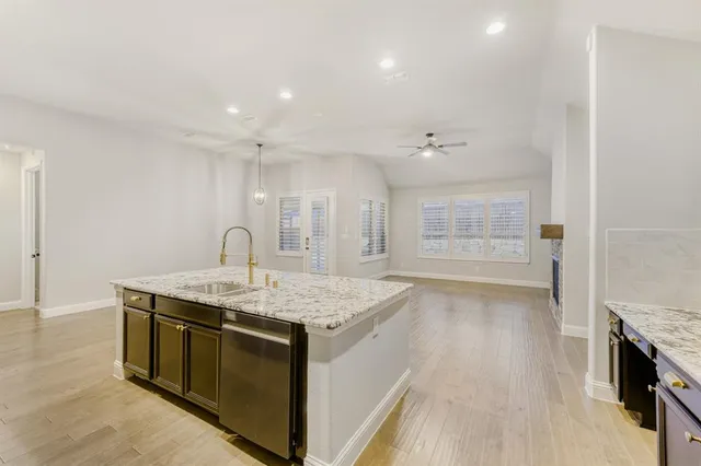 a kitchen with a stove a sink and a refrigerator