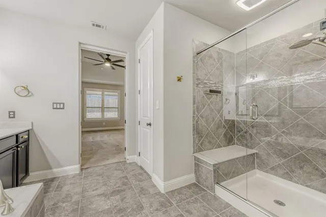 a bathroom with a shower and a sink