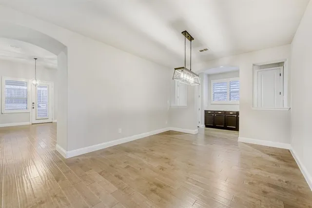 wooden floor in an empty room with a fireplace