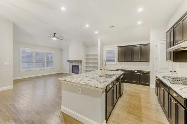 a kitchen with stainless steel appliances granite countertop a stove and a sink