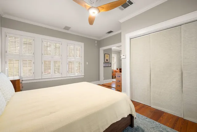 a bedroom with a bed and a large window with outer view