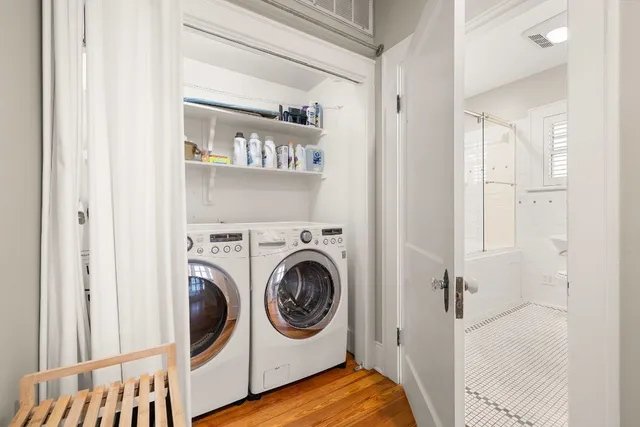a view of a bedroom with washer and dryer