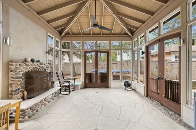 a room with gym equipment and large windows