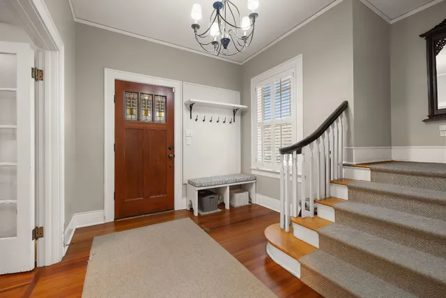 a view of entryway and hall with wooden floor