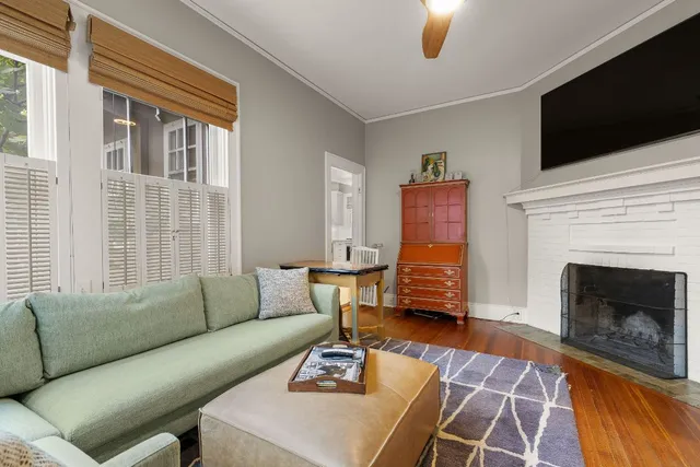 a living room with furniture a flat screen tv and a fireplace
